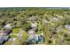 This aerial shot captures the home's location, backyard, nearby streets, and lush greenery at 1730 John Arthur Way, Lakeland, FL 33803