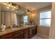 A double vanity bathroom with decorative lighting and granite countertops at 1730 John Arthur Way, Lakeland, FL 33803