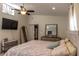 Bright bedroom featuring a ceiling fan, TV, a dresser and closet at 1730 John Arthur Way, Lakeland, FL 33803