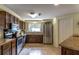 A well-lit kitchen with stainless steel appliances, tile flooring, and granite countertops at 1730 John Arthur Way, Lakeland, FL 33803