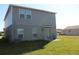 Exterior back of two-story home with a small patio and grassy yard at 1753 Eagle Hammock Blvd, Eagle Lake, FL 33839