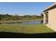 Backyard view overlooking pond with lush green surroundings and trees at 1753 Eagle Hammock Blvd, Eagle Lake, FL 33839