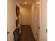 Hallway featuring hardwood floors and multiple decor items hung on the wall at 1753 Eagle Hammock Blvd, Eagle Lake, FL 33839