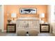 Stylish Bedroom features a crib with neutral decor, complemented by twin side tables and a blue whale wall art at 2959 Savoir Ave, Davenport, FL 33837