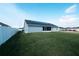 Spacious, grassy backyard featuring a white fence for privacy and solar panels on roof at 891 Galloway St, Lake Alfred, FL 33850