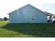 Backyard of home featuring green grass, white stones, and blue siding at 891 Galloway St, Lake Alfred, FL 33850