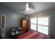 Cozy bedroom featuring plantation shutters, light blue painted walls, and a ceiling fan at 891 Galloway St, Lake Alfred, FL 33850