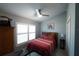 Cozy bedroom featuring a ceiling fan, plantation shutters, and light blue painted walls at 891 Galloway St, Lake Alfred, FL 33850