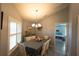 Cozy dining room with a chandelier, shuttered windows, and charming decor, ideal for Gathering meals at 891 Galloway St, Lake Alfred, FL 33850