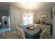 Bright dining room with chandelier, plantation shutters, and neutral walls at 891 Galloway St, Lake Alfred, FL 33850