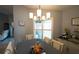 Formal dining room with traditional chandelier, plantation shutters, and tasteful decor at 891 Galloway St, Lake Alfred, FL 33850