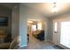 Inviting foyer with tile flooring and view into the adjacent sitting room at 891 Galloway St, Lake Alfred, FL 33850