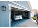 View of open garage with white car parked inside at 891 Galloway St, Lake Alfred, FL 33850