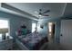 Serene main bedroom with a tray ceiling, ceiling fan, and ensuite bathroom at 891 Galloway St, Lake Alfred, FL 33850