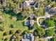 Aerial view of lush landscaped homes with private pools and circular driveways at 17416 Magnolia Island Blvd, Clermont, FL 34711