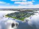 Stunning aerial view of the peninsula neighborhood showing private docks and glistening lake at 17416 Magnolia Island Blvd, Clermont, FL 34711