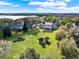 Expansive backyard featuring lush lawn, mature trees, and a sparkling screened-in pool, perfect for outdoor living at 17416 Magnolia Island Blvd, Clermont, FL 34711