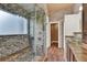 Updated bathroom featuring a tiled shower, glass door, and a marble bench at 17416 Magnolia Island Blvd, Clermont, FL 34711