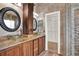 Modern bathroom featuring dual vessel sinks, granite countertops and tiled walls at 17416 Magnolia Island Blvd, Clermont, FL 34711