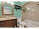 The updated bathroom offers a large mirror and shower tub combination at 17416 Magnolia Island Blvd, Clermont, FL 34711