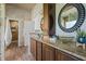 Stylish bathroom with custom vanities, unique glass vessel sinks, and stone tile at 17416 Magnolia Island Blvd, Clermont, FL 34711