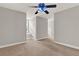 Spacious bedroom with neutral walls and carpet with bright ceiling fan at 17416 Magnolia Island Blvd, Clermont, FL 34711