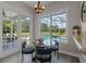 Cozy breakfast nook with a pool view and modern chandelier lighting at 17416 Magnolia Island Blvd, Clermont, FL 34711