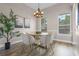 Bright dining room with modern chandelier, wood table, and neutral decor at 17416 Magnolia Island Blvd, Clermont, FL 34711