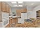 Well-lit kitchen with granite countertops, and modern appliances including built-in oven and microwave at 17416 Magnolia Island Blvd, Clermont, FL 34711