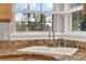 Close up of kitchen sink with granite counters, chrome faucet and fixtures, and window at 17416 Magnolia Island Blvd, Clermont, FL 34711