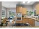 Well-lit kitchen featuring granite counters, stainless appliances, and bright natural light at 17416 Magnolia Island Blvd, Clermont, FL 34711
