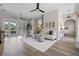 Open living room with wood floors, modern furnishings, and easy access to the outdoors at 17416 Magnolia Island Blvd, Clermont, FL 34711