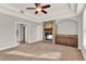 Spacious main bedroom with a stone fireplace, tray ceiling, and carpet floors at 17416 Magnolia Island Blvd, Clermont, FL 34711