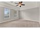 A large bedroom features tray ceilings and two windows at 17416 Magnolia Island Blvd, Clermont, FL 34711