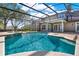 Beautiful private pool with a screened enclosure and serene backyard views at 17416 Magnolia Island Blvd, Clermont, FL 34711