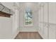 Bright walk-in closet featuring wire shelving and a window for natural light at 17416 Magnolia Island Blvd, Clermont, FL 34711