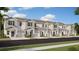 New townhomes feature attached garages and modern architectural design in a landscaped community at 2592 Skyline Loop, Kissimmee, FL 34758