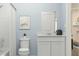 Cozy bathroom features a white vanity with a quartz countertop and neutral wall art at 2610 Skyline Loop, Kissimmee, FL 34758