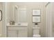 Contemporary bathroom featuring a vanity with a granite countertop, framed art, and a shower with a curtain at 3111 Zuni Rd, St Cloud, FL 34771