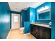 Modern bathroom featuring blue walls, granite countertop and dark wood vanity at 4739 Tierra Alta Ct, Lakeland, FL 33813