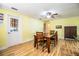 Sunny dining room with hardwood floors, wood table, and a ceiling fan at 4739 Tierra Alta Ct, Lakeland, FL 33813