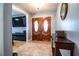 Inviting foyer featuring warm double doors and tile flooring, creating a welcoming entrance to the home at 4739 Tierra Alta Ct, Lakeland, FL 33813