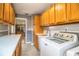 Laundry room featuring wooden cabinets, white appliances, and practical layout at 4739 Tierra Alta Ct, Lakeland, FL 33813