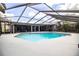 A tranquil backyard with a screened-in pool, a grill and a patio area at 4739 Tierra Alta Ct, Lakeland, FL 33813