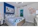 Vibrant bedroom with a blue accent wall, playful decor, and a comfortable bed at 479 Pine Tree Blvd, Lake Alfred, FL 33850