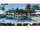 Resort-style pool area surrounded by palm trees, lounge chairs, and lush landscaping at 9533 Passaic Pkwy, Orlando, FL 32829