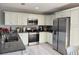 Modern kitchen with stainless steel appliances, granite countertops, and ample cabinet space at 15068 Sw 43Rd Ct, Ocala, FL 34473