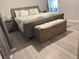 Primary bedroom showcasing neutral tones, a king bed, and an accent storage bench at 15068 Sw 43Rd Ct, Ocala, FL 34473