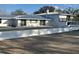 Rear view of the home showing the patio, white walls and a spacious backyard at 1912 Providence Rd, Lakeland, FL 33805