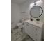 Bathroom featuring a vanity with white cabinets, white countertop and a round mirror at 1912 Providence Rd, Lakeland, FL 33805